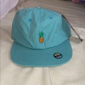 Aqua blue strapback cap with a pineapple design.